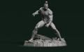 A 3D rendering of a muscular, bald, and battle-ready figure standing on a rocky base against a dark green background.