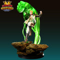 A 3D printed figurine of a person in a white outfit, holding a green object, standing on a rock formation against a dark background.