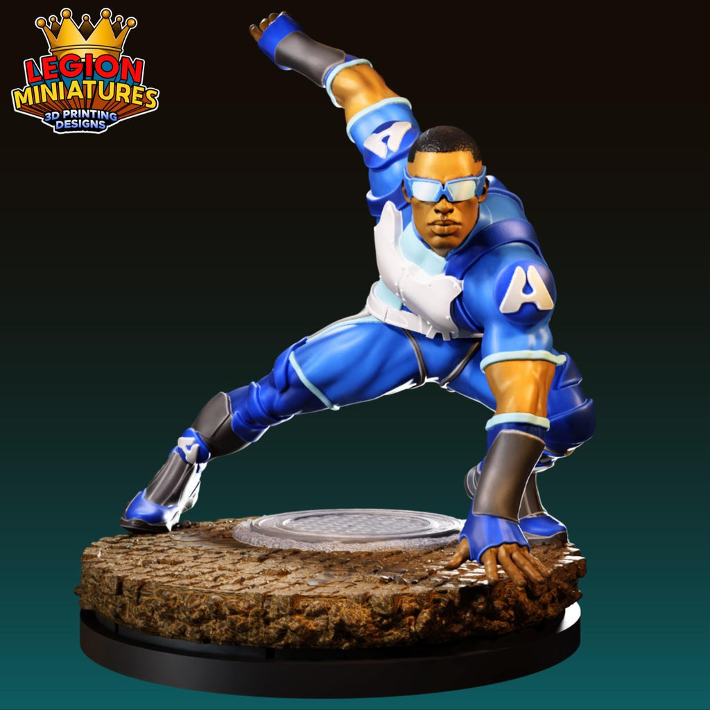 A figurine of a superhero character in a blue suit and sunglasses, with one arm raised and the other bent at the elbow, standing on a platform.