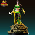 A 3D printed figurine of a female character in a green and yellow outfit, standing on a pile of rubble.