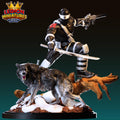 A 3D printed figurine of a character in a fighting stance, holding a weapon and accompanied by a wolf-like creature.