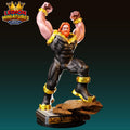 A 3D printed figurine of a muscular, bearded man with a red beard, wearing a black and gold suit, standing on a rock and flexing his muscles.