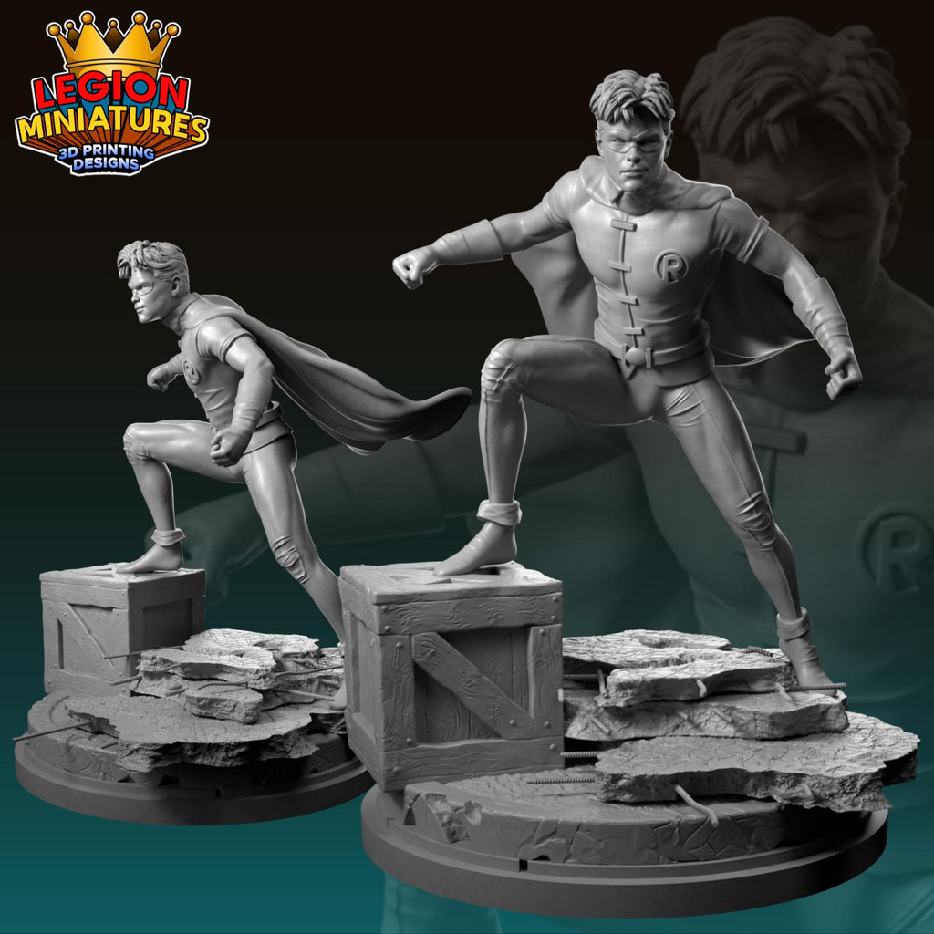 two 3D printed miniatures of superhero characters, including a male figure with a cape and a female figure with a cape.