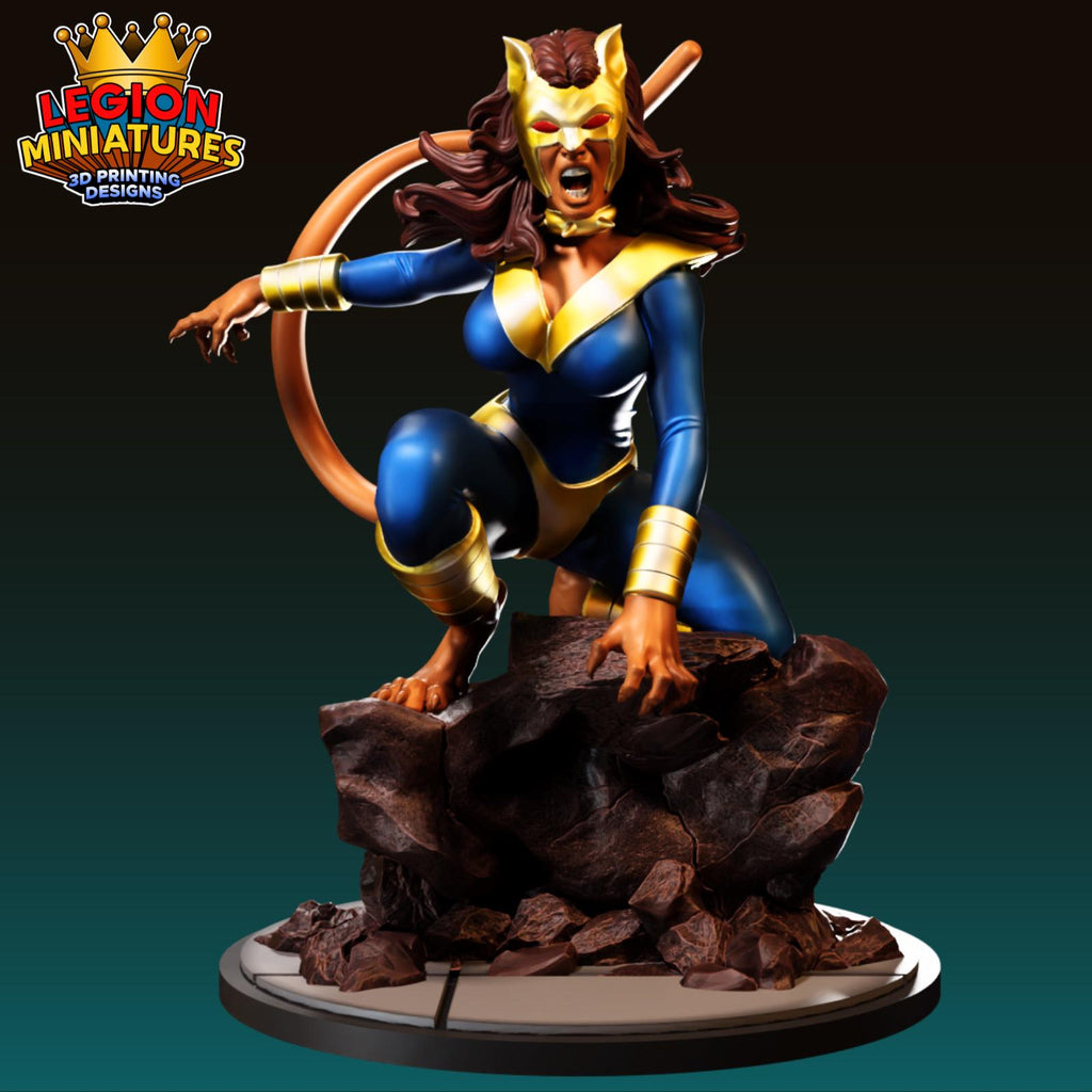 A figurine of a female character in a blue and gold costume, with a fierce expression, standing on a rocky base.