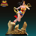 A 3D printed figurine of a female superhero character, wearing a red and gold costume, is shown in an action pose with a wreath around her neck.