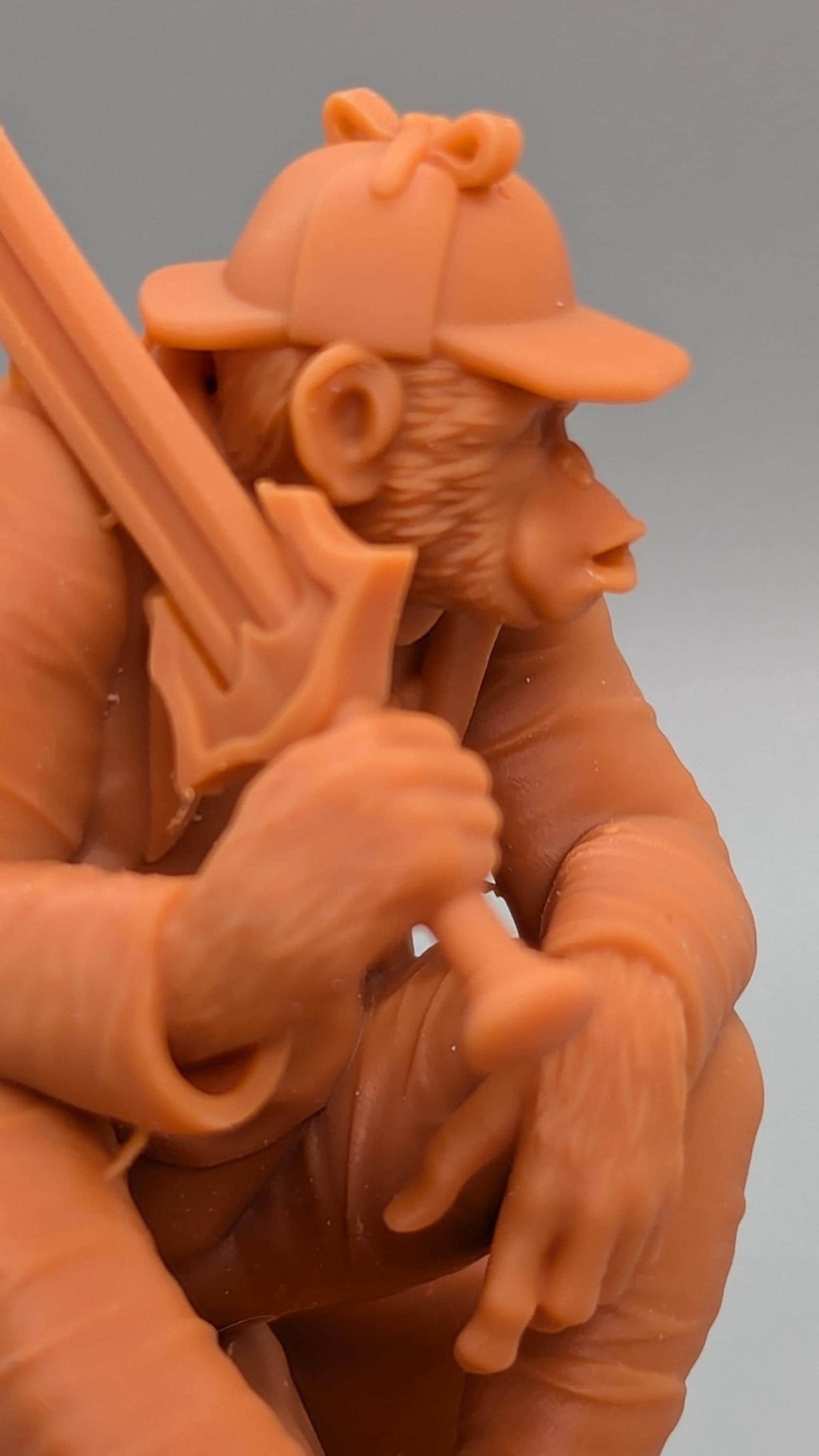 A close-up of a toy figurine of a monkey holding a sword.
