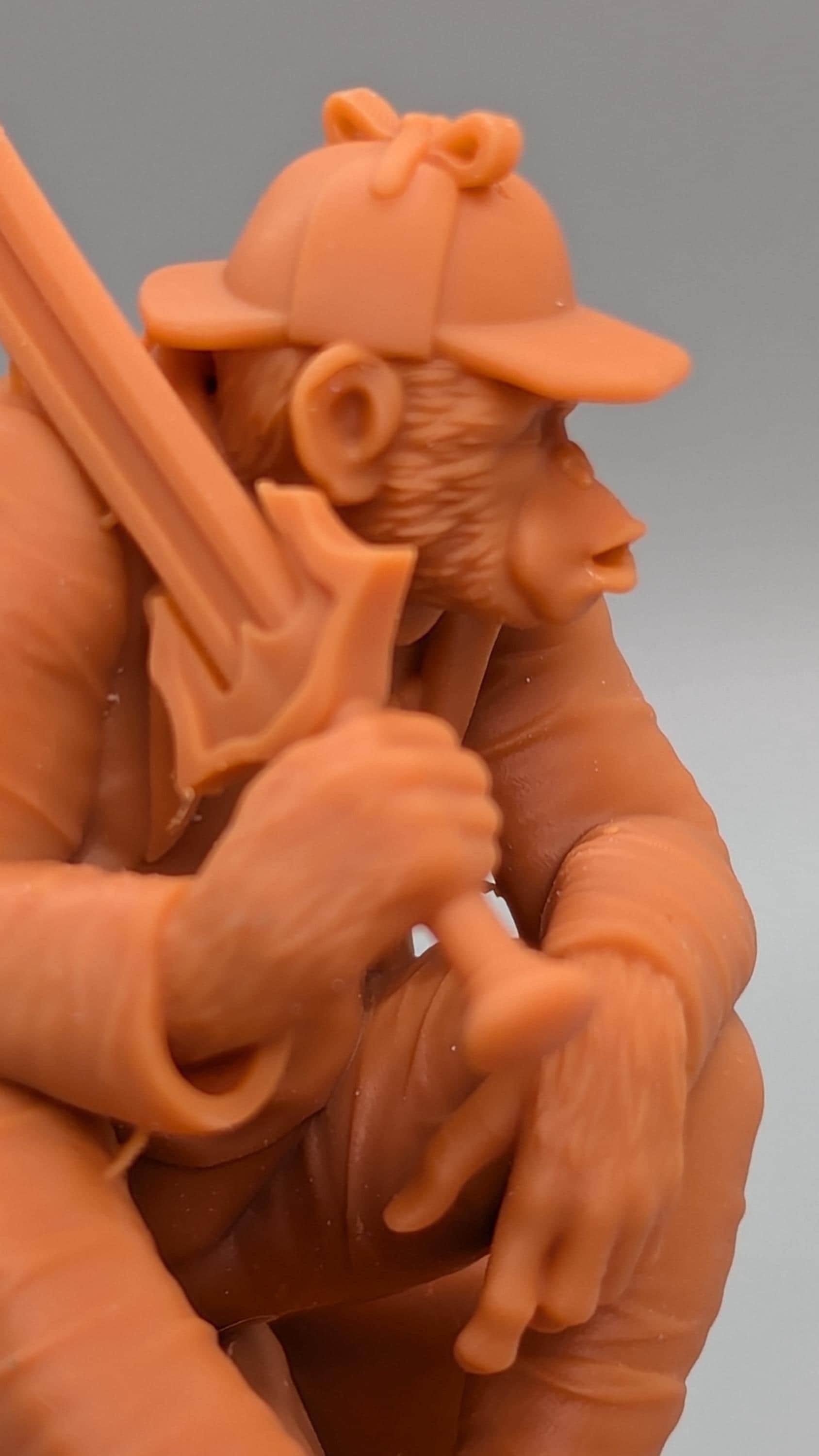 A close-up of a toy figurine of a monkey holding a sword.