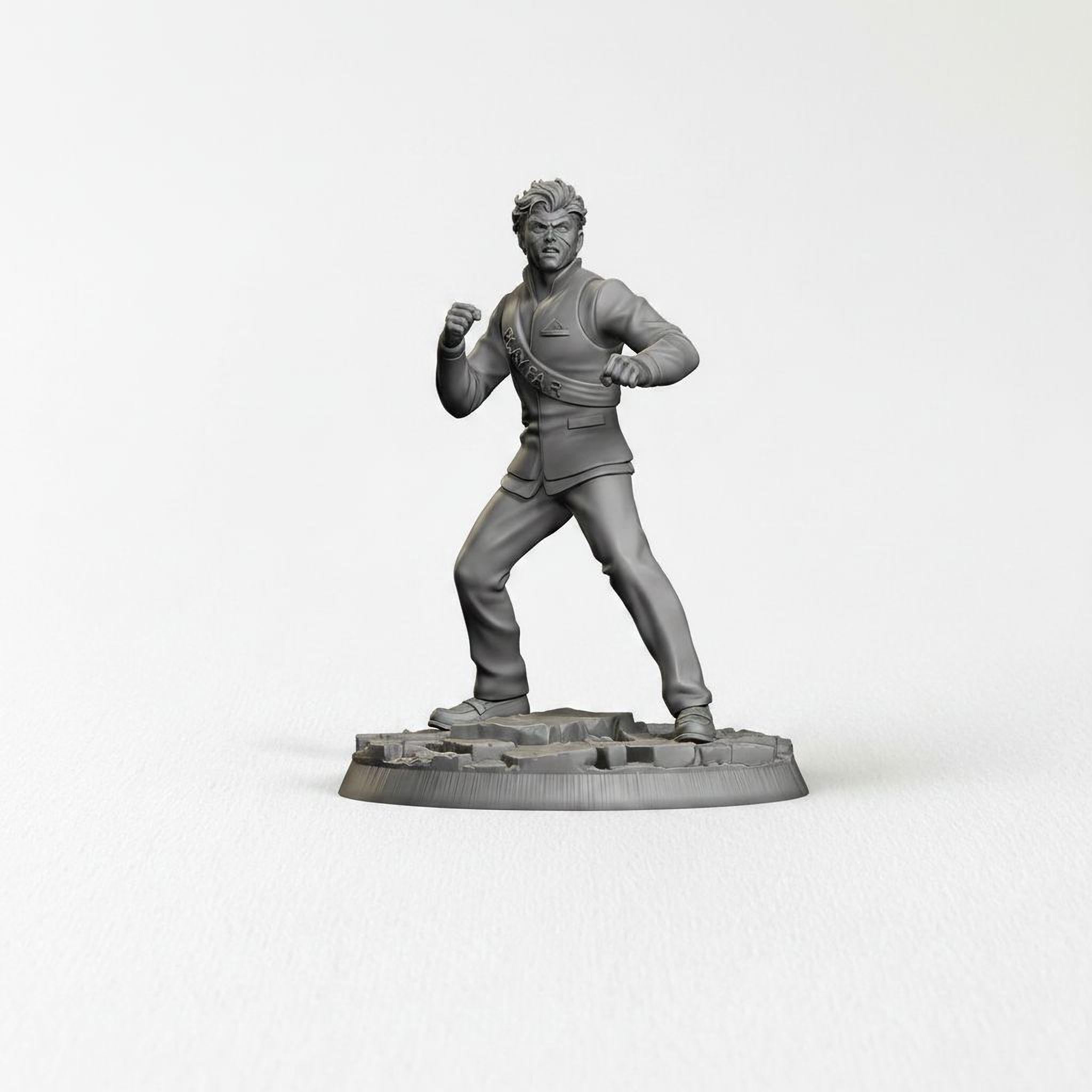 A black and white image of a statue of a man in a fighting stance, standing on a base.