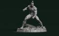 A 3D rendering of a muscular, bald, and battle-ready figure standing on a rocky base against a dark green background.
